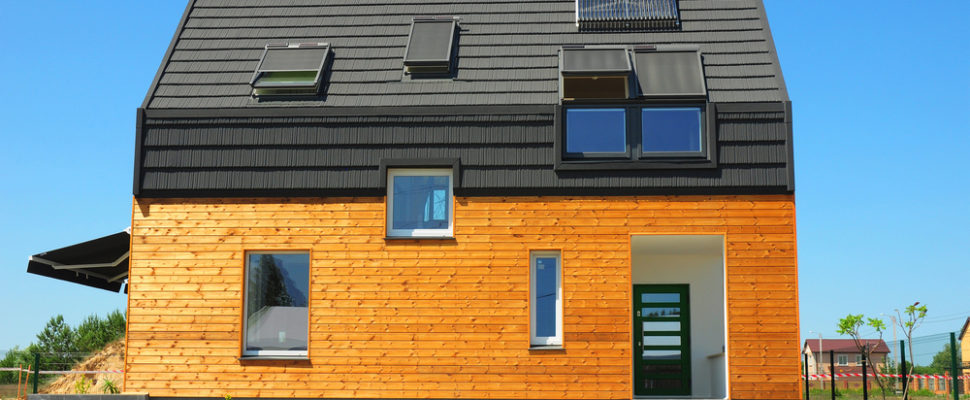 Modern House Exterior Design. New Building House Energy Efficiency Solution Concept Outdoor. Solar Energy, Solar Water Heater, Solar Panels, Skylights, Ventilation, Installed on Bitumen Tiled Roof.